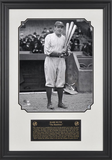 Photo of Babe Ruth posing with three bats