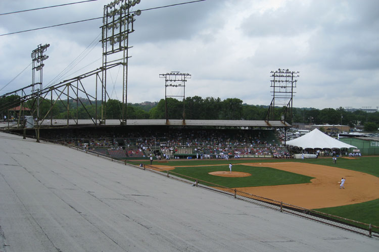 The light towers jut out from the roof at Rickwood Field