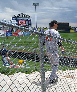Visiting players must walk a few feet from fans on steps between the third base grandstand and berm