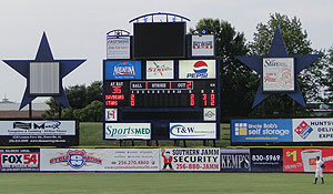 Billboards shaped like stars are on each side of the scoreboard at Joe Davis Stadium